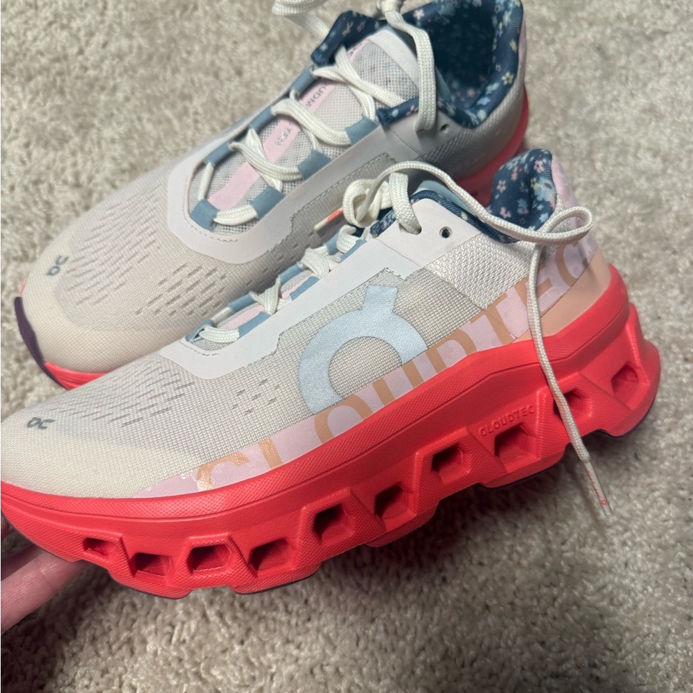 On Running Sneakers with Red Soles and Light Gray Uppers